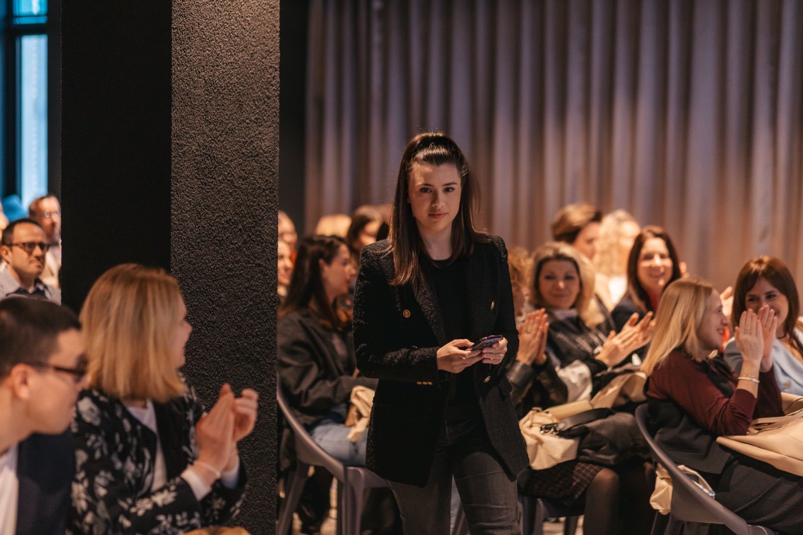 Thea on stage at a conference